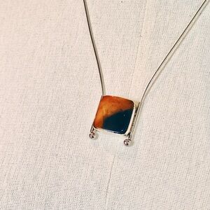 Elegant Silver Necklace with Orange and Blue Pendant